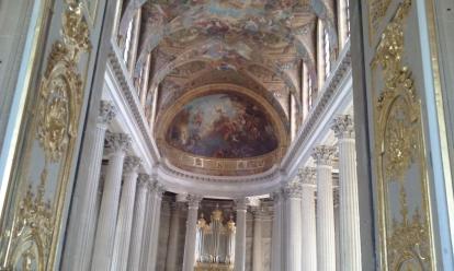 The Chapel at Versailles. The walls are filled with ornate work throughout the palace. 