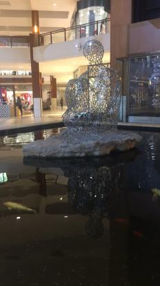 Plensa Floridaâ€™s Soul statue with koi pond at Aventura Mall