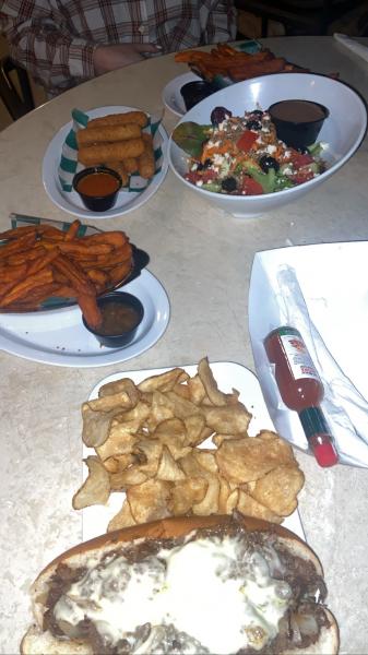 Mozzarella sticks, sunset salad, sweet potatoe fries, and Philly cheesesteak sandwich at M
