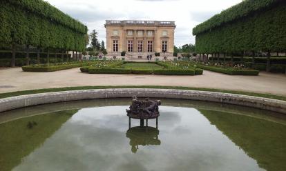 Le Petit Trianon at Versailles. A beautiful symmetric garden with a pond. The gardens of V