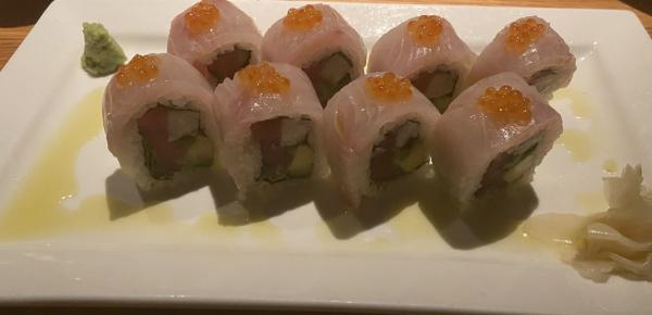 Hitamasa roll pictured spicy tuna and avocado roll, wrapped with hiramasa sashimi, topped 