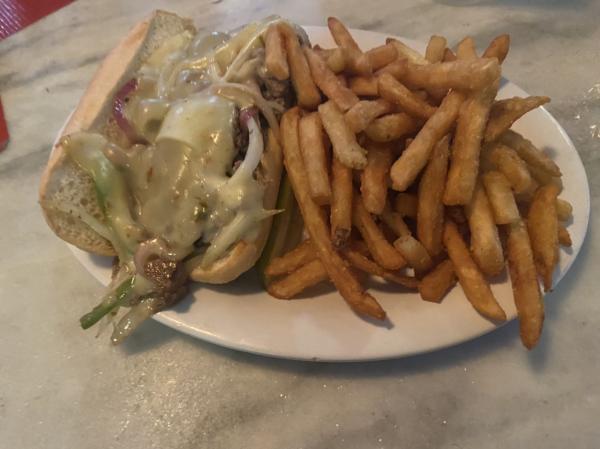 Philly Cheesesteak with fries and pickle at Lorelei Restaurant & Cabana Bar Islamorada