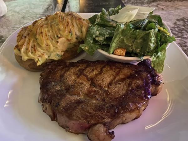Ribeye at Moxieâ€™s with a loaded potato and Cesar salad. #food